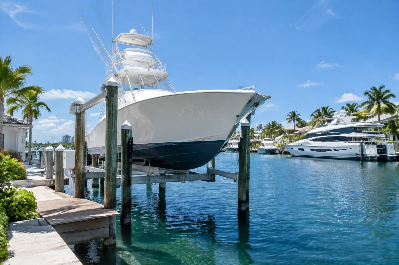 Sport-fishing boat on a heavy boat lift with tall pilings on a wide residential canal