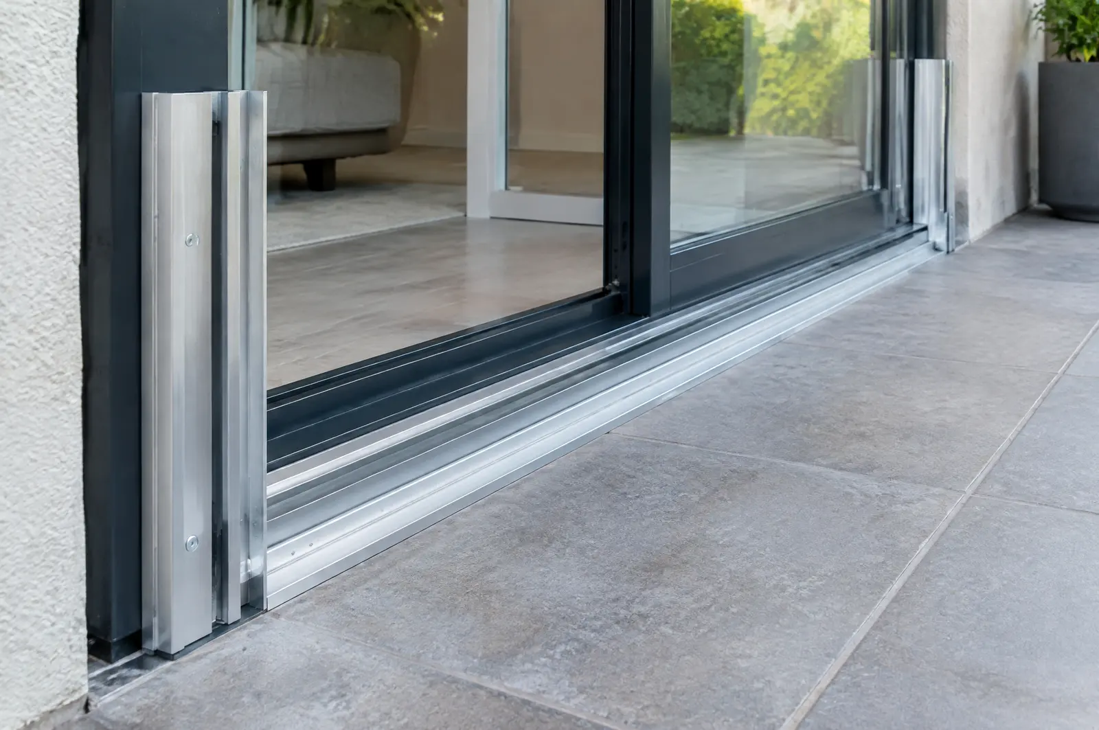 Aluminium side tracks on a door frame ready to receive removable flood panels
